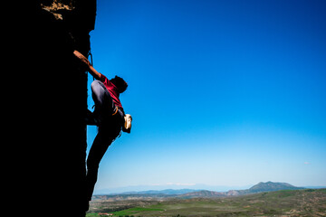 Male rock climber on challenging route