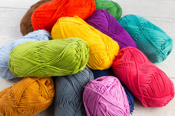 Pile of multi-colored skeins of yarn