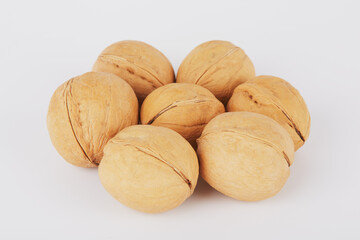 Walnuts all around lying on a white background