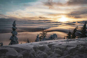 Sunset View From Top of the mountain with Trees and Low Clouds with snow in Europe
