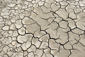 Cracked soil due to the long dry season. Rivers, lakes or ponds can dry and crack like this to form an irregular circle or hexagon pattern. Droughts like this often occur in African countries