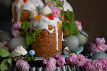 Dark Easter. Easter cakes and eggs with flowers. sakura, spring blooming