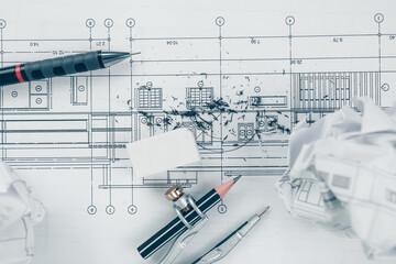 eraser crumbs, compass and pencil  on drawing design working on blueprint. House planning design...