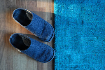 Paar Blaue Filzpantoffeln auf einem Holzboden