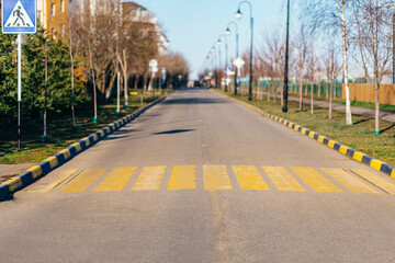 Yellow pedestrian crossing on an asphalt road