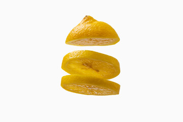 Yellow lemon slices in a row on top of each other. Lemon is isolated on a white background.