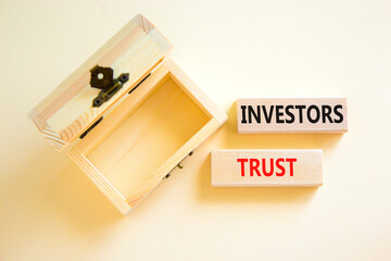 Investors trust symbol. Concept words Investors trust on wooden blocks on a beautiful white table...