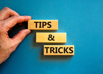 Tips and tricks symbol. Concept words Tips and tricks on wooden blocks. Beautiful blue table blue...
