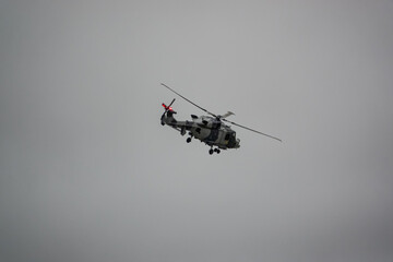 British army AgustaWestland AW159 Wildcat AH1 helicopter flying on military training exercises, Wiltshire UK