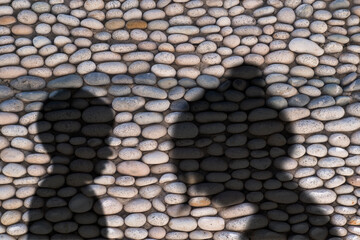 Naklejka premium Shadow of mother and child on stone texture