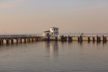 Obraz premium Marine pier for boats and yachts against the backdrop of the sunset. The Gulf of Finland.