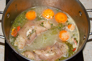 cooking broth from pork knuckle with vegetables. Preparation for jelly from pork meat
