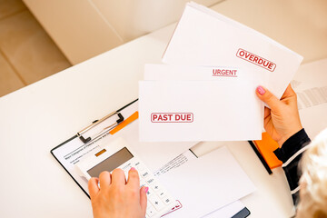 The accountant prepares debt letters as a concept of growing delinquent debts, rising prices and...