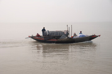 Naklejka na ściany i meble fisherman of bengal catching fish in the river