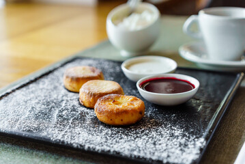 photo of traditional rustic sweet bun cakes with cream cheese inside and powder sugar on surface.