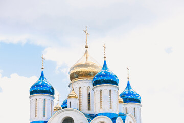 Blue and golden domes of white orthodox church