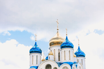 Blue and golden domes of white orthodox church