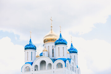 Blue and golden domes of white orthodox church
