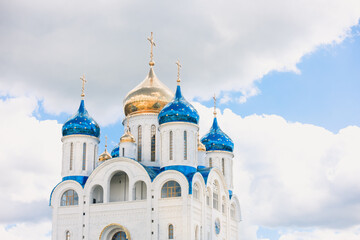 Blue and golden domes of white orthodox church