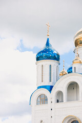 Blue and golden domes of white orthodox church