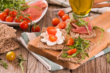 crispy rye bread with sesame seeds, ham and cottage cheese.