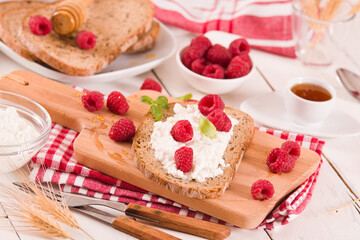 Rye bread with cottage cheese and raspberries.