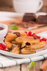 Mini churros with chocolate dipping sauce.