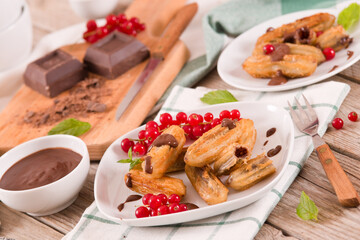 Mini churros with chocolate dipping sauce.