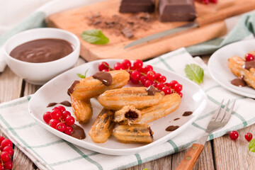 Mini churros with chocolate dipping sauce.