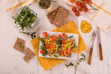 crispy rye bread with sesame seeds, arugula and sweet corn.