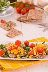 crispy rye bread with sesame seeds, arugula and sweet corn.