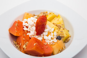 Plate of nutritious fruits for breakfast on white background