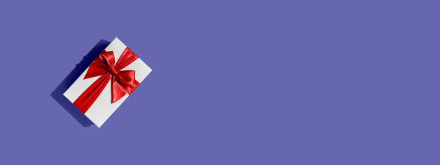 Banner with gift box and copy space on background toned in very peri color