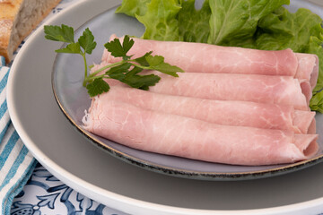 slice of white ham in a plate on a table