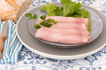 slice of white ham in a plate on a table