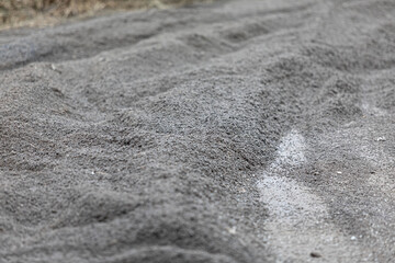 Fine gravel embankment on the track of the road for motorcycle racing. Traces from the tires of cars and motorcycles. Competition Speed Rally