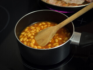 beans and bacon in frying pan