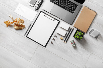 Laptop and blank stationery set on wooden background. Business concept. Flat lay.