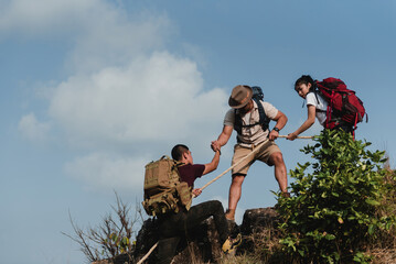 Three Asian teenagers, mountain climber, trekker and traveler. Traveling on top of a mountain,...