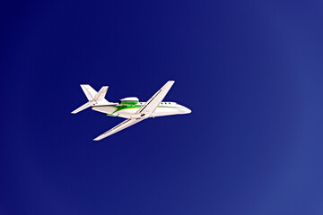 A private jet flying in the blue sky
