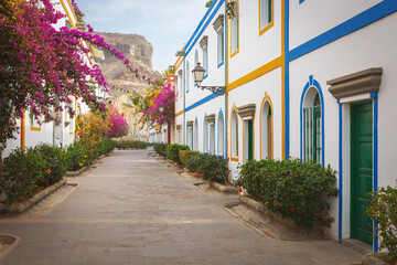 Fototapeta na wymiar Street with bougainvillea flowers in Puerto Mogan, Gran Canaria island, Spain