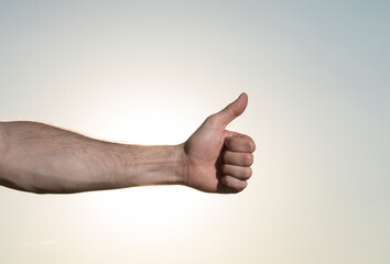 thumb up gesture. Yes. Gesture. Finger. Ok. Man hand. Sky background. 