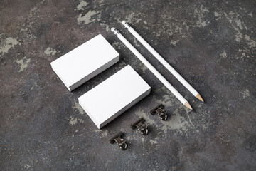 Blank business cards and pencils on concrete background. Template for ID.