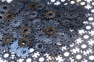 Lots of new steel gears in oil close-up.