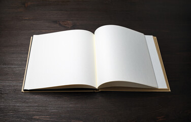 Blank brochure or book mock up on wood table background.