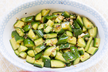 A delicious and refreshing spicy asian cucumber salad that is tossed with oil, garlic, chili flakes, and sesame seeds.