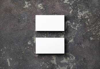 Photo of two blank business cards on concrete background. For design presentations and portfolios. Top view. Flat lay.