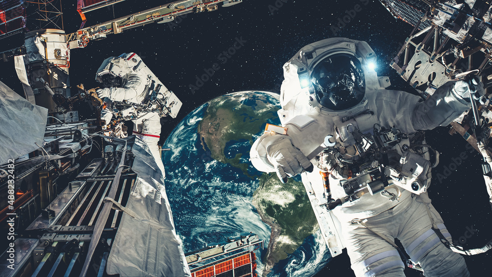 Wall mural astronaut spaceman do spacewalk while working for spaceflight mission at space station . astronaut w