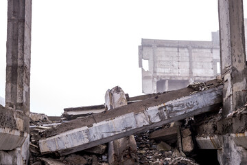 The destroyed foundation and construction debris with huge concrete fragments against the...