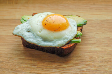 sandwich black Borodino bread with avocado and fried egg pepper salt